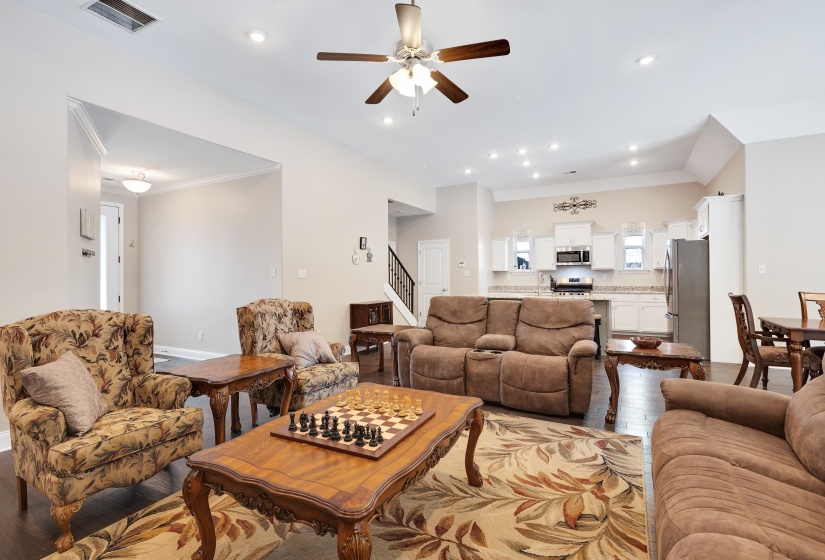 Open-concept living space featuring wood-finish flooring and a ceiling fan