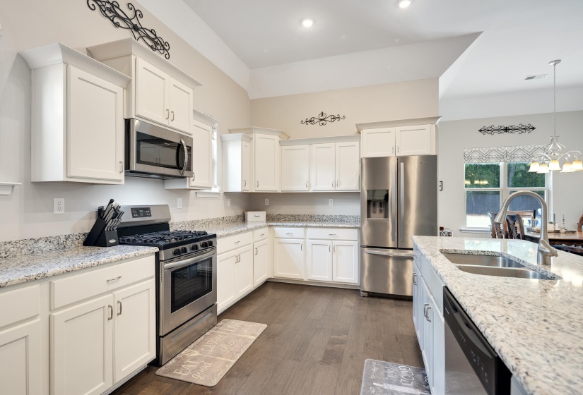 Kitchen featuring white cabinetry and light-toned countertops