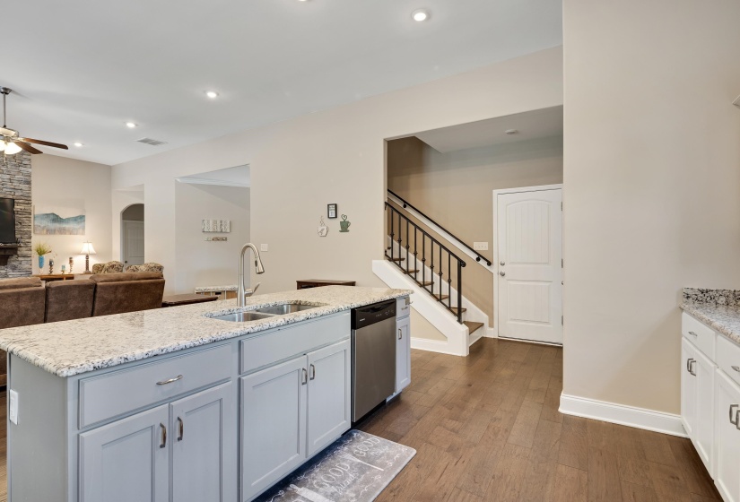 Kitchen island with integrated sink, stainless steel faucet, and granite countertop