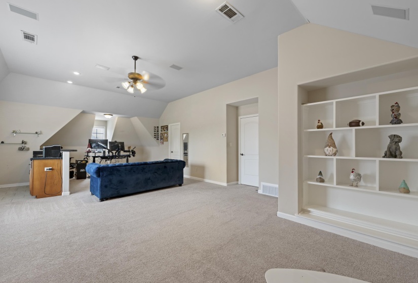 Spacious bonus room featuring sloped ceilings, recessed lighting, and light-tone carpeting