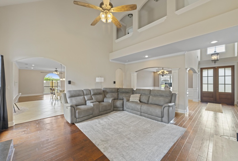 Expansive living area featuring soaring ceilings and dark wood-finish flooring