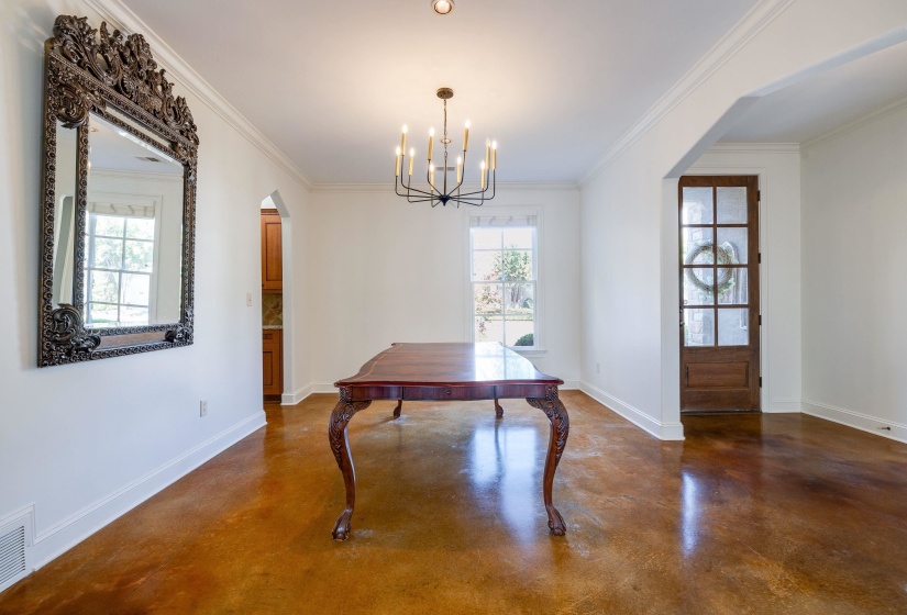 Dining room featuring crown molding and a notable chandelier