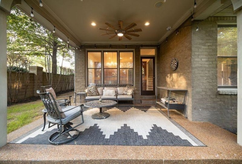 View of patio with outdoor lounge area and ceiling fan