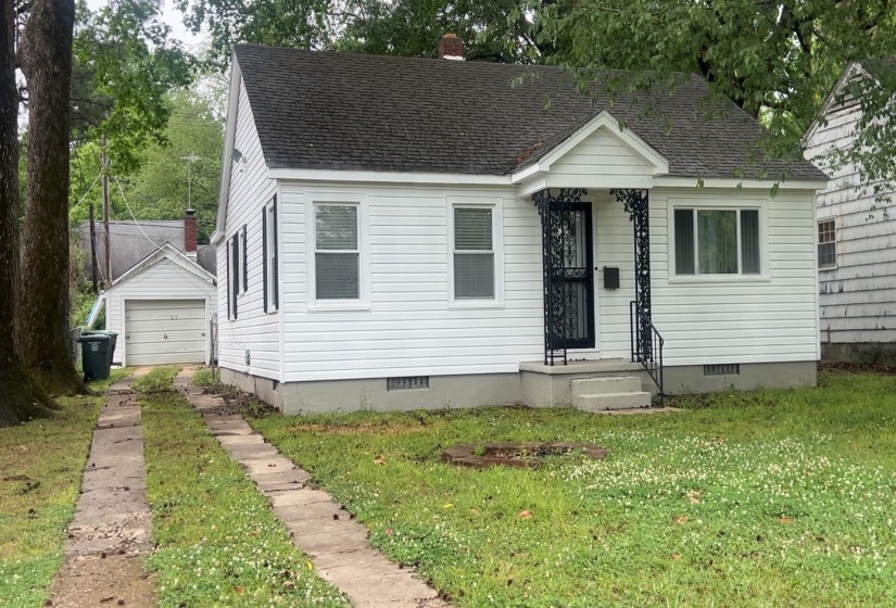 White siding exterior with a dark shingle roof