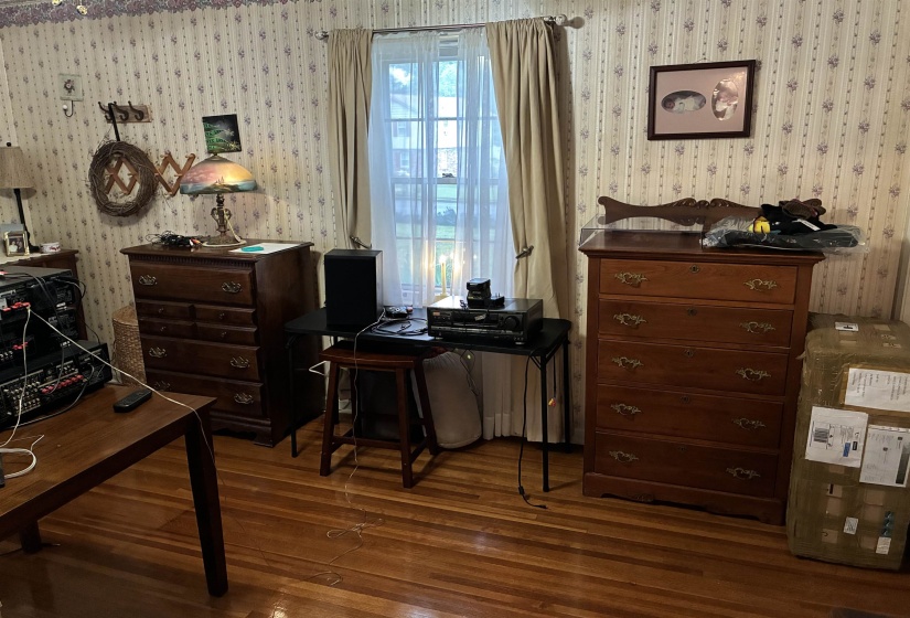 Wood-finish flooring complemented by patterned wallpaper