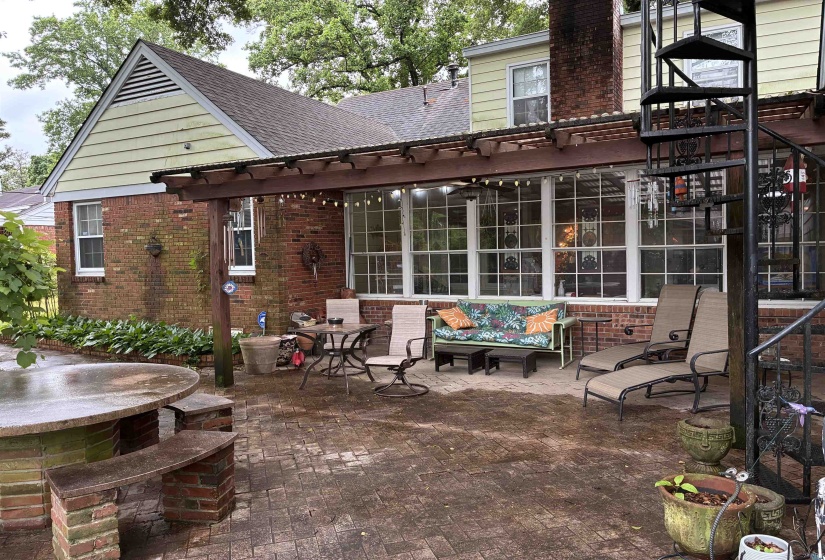 Brick exterior with a large patio featuring brick pavers