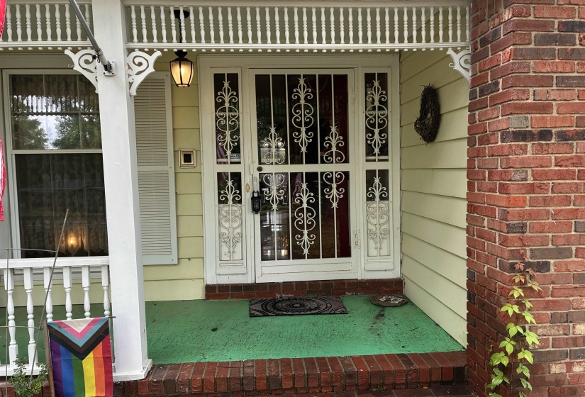 Brick exterior featuring a covered porch with decorative balusters and pillar accents