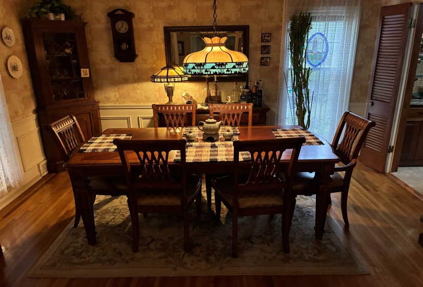 Dining space featuring hardwood flooring and a decorative area rug
