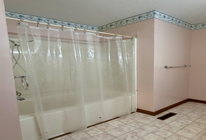 Bathroom featuring a tub/shower combination with a single-handle faucet and a wall-mounted shower head