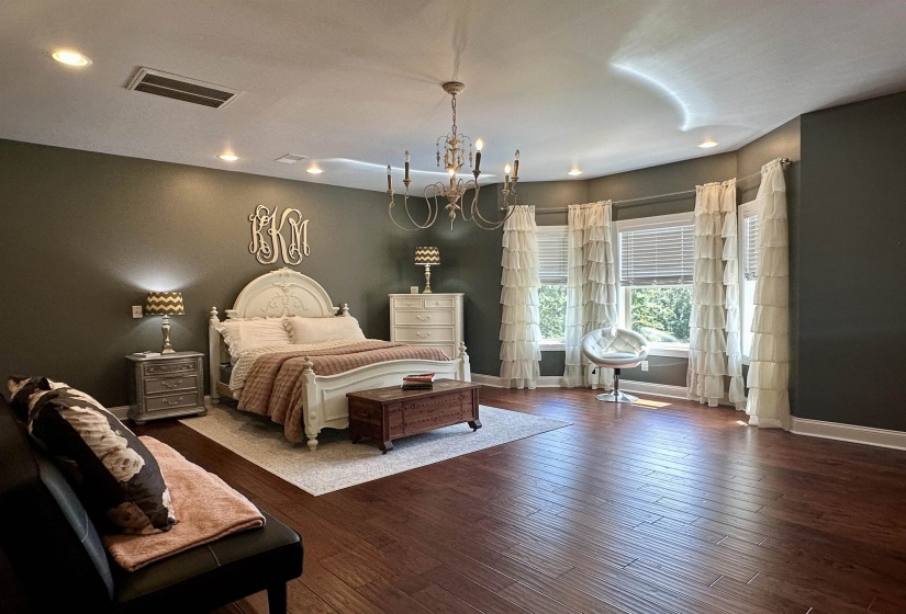 Bedroom featuring dark wood finished floors, a chandelier, and recessed lighting