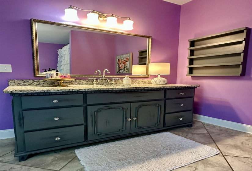 Full bathroom with baseboards and vanity