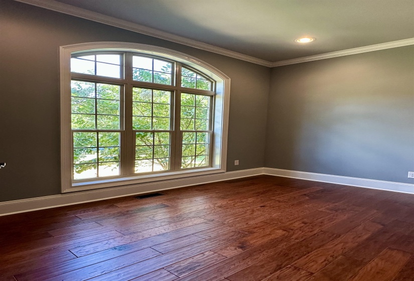 Unfurnished room featuring crown molding, dark wood-type flooring, and recessed lighting