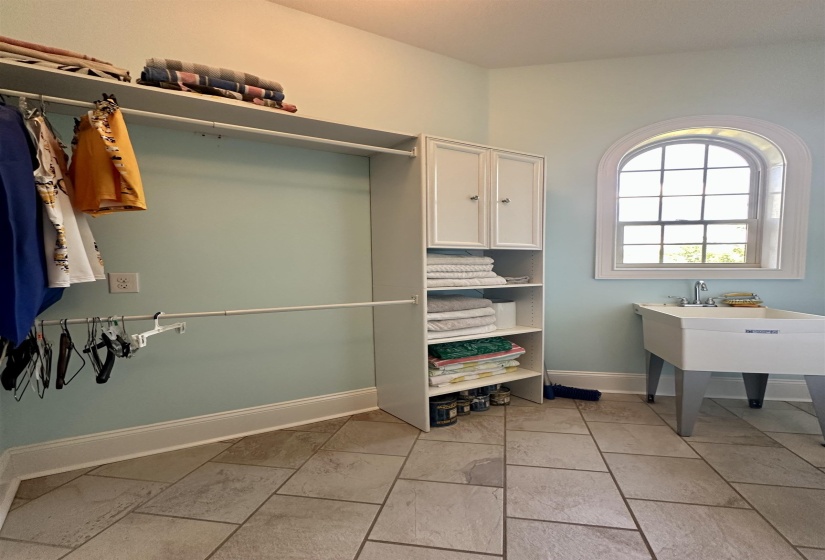 Spacious closet with light tile patterned floors