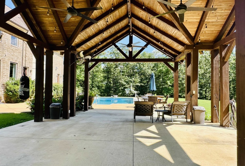 View of patio with a ceiling fan, an outdoor pool, and outdoor dining space