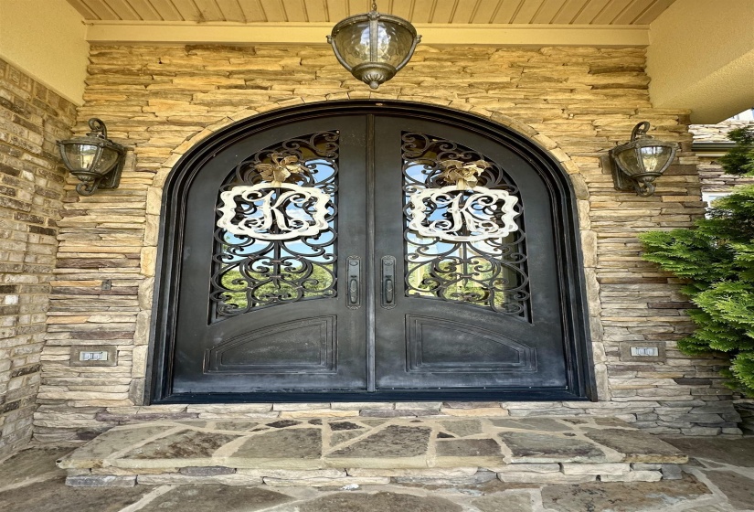 Property entrance with stone siding and brick siding