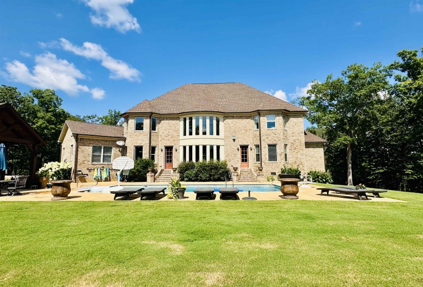 Back of house featuring a patio area, an outdoor pool, and a yard