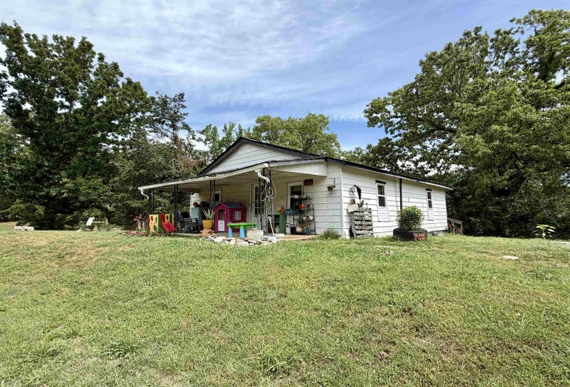 Single-story residence featuring white siding and a covered front porch