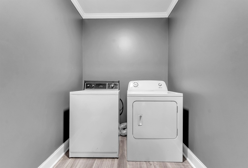 Dedicated laundry area featuring a white washing machine and dryer