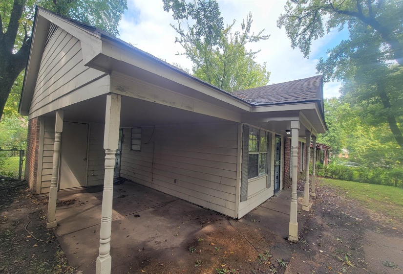 View of property exterior with a carport