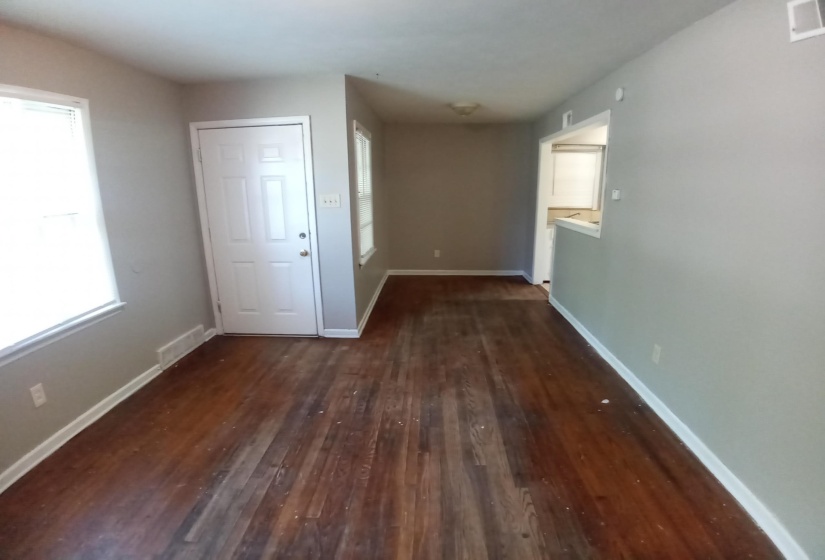 Interior space with a wealth of natural light and dark hardwood / wood-style flooring