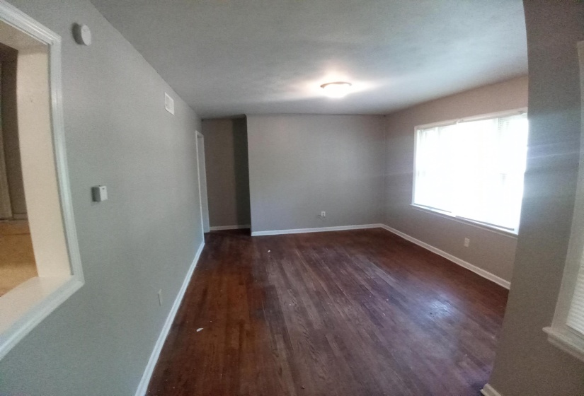 Unfurnished room with dark hardwood / wood-style flooring