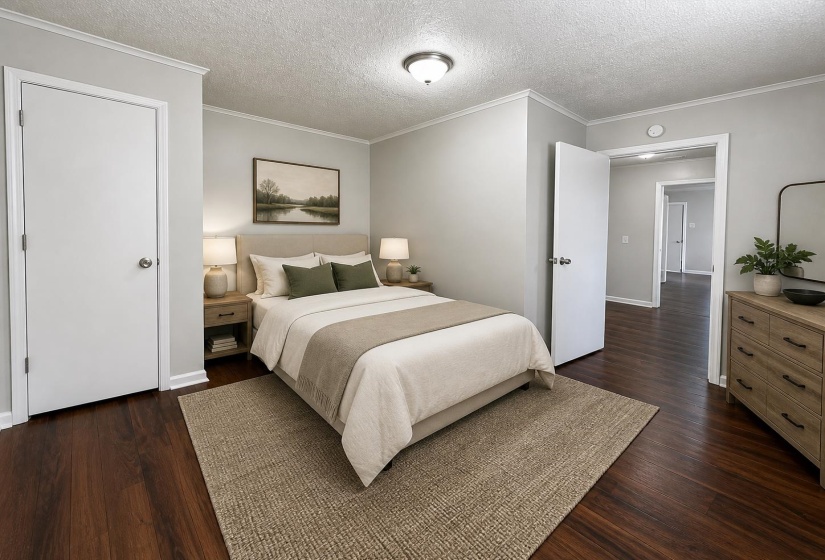 Spacious room featuring wood-finish flooring, light grey walls, and white crown molding