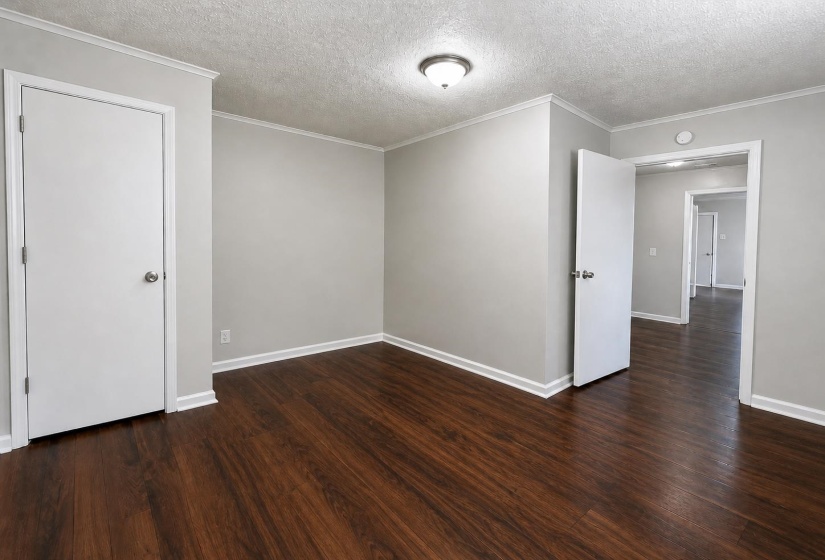 Room featuring wood-finish flooring, light gray walls, white trim, and a semi-flush mount ceiling light