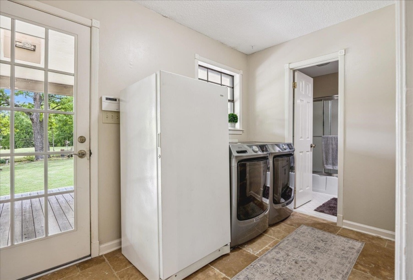 Laundry area with tile flooring and direct exterior access