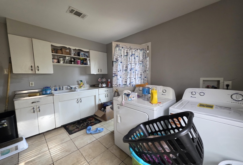 Utility room featuring tile flooring and painted walls
