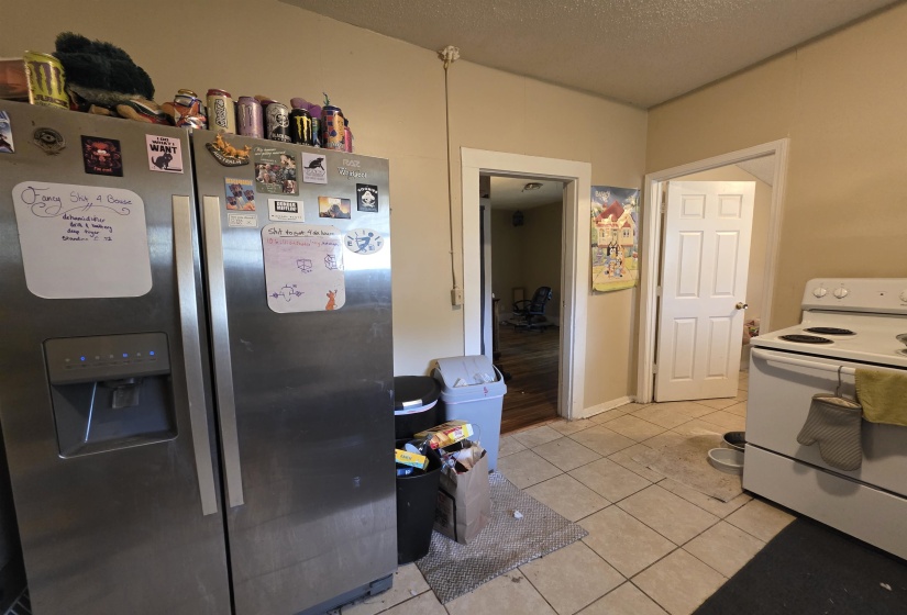 Kitchen space featuring neutral tone walls and tile flooring