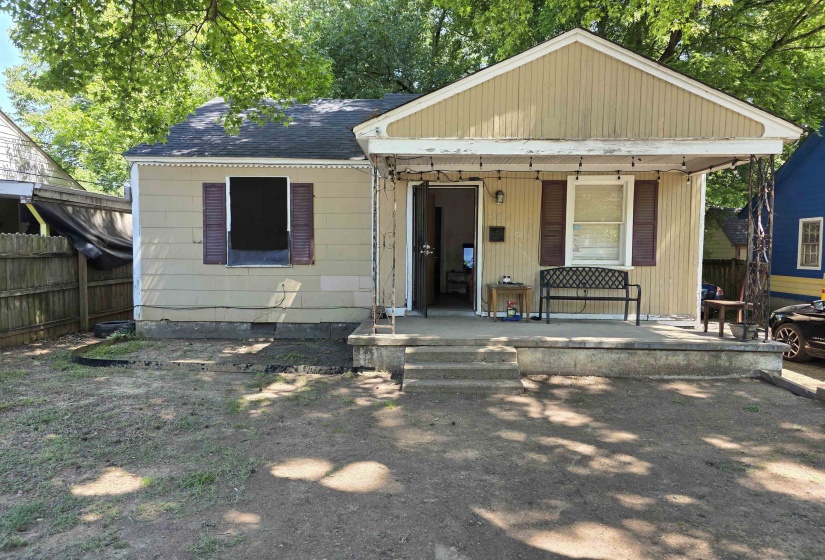 Exterior featuring a covered porch, three-step concrete entry, horizontal siding, and decorative window shutters