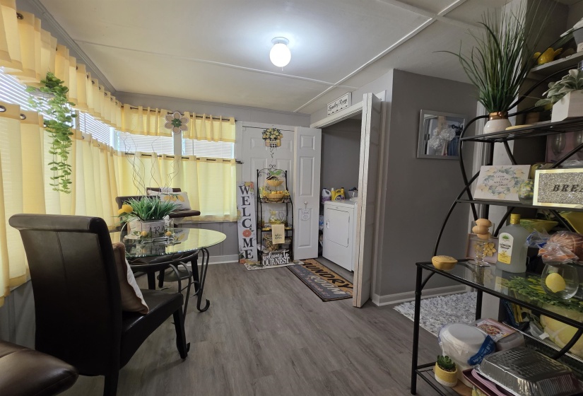 Room featuring wood-finish flooring and multiple windows with blinds