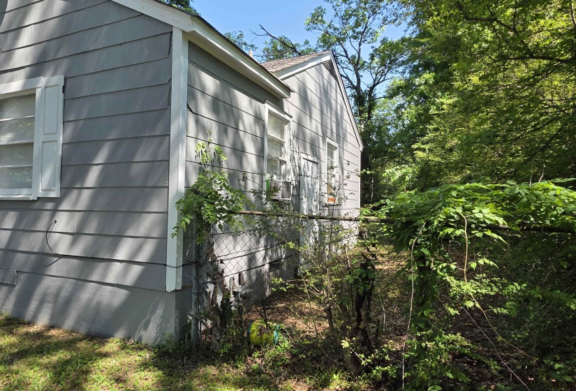 Gray horizontal siding with white trim and white louvered shutters