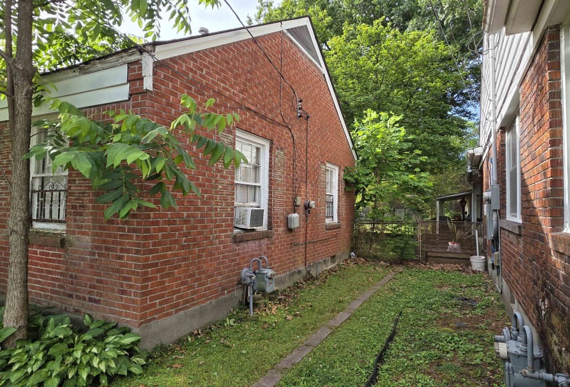 Brick exterior featuring multiple windows and a gabled roofline