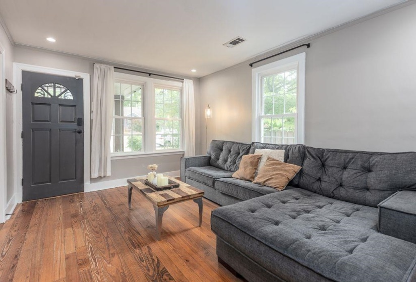 Warm-toned wood-finish flooring complements light gray walls
