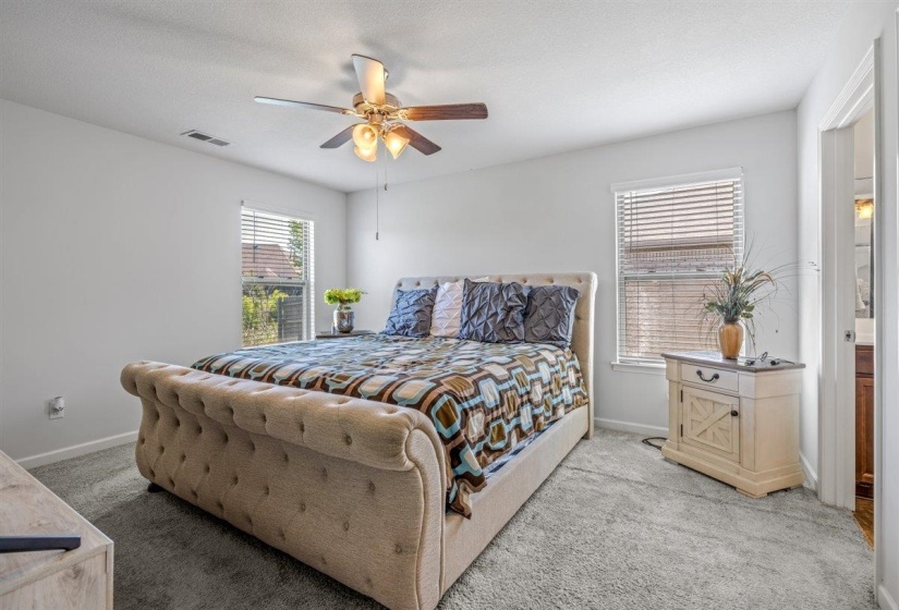 Spacious room featuring light gray carpeting and white walls