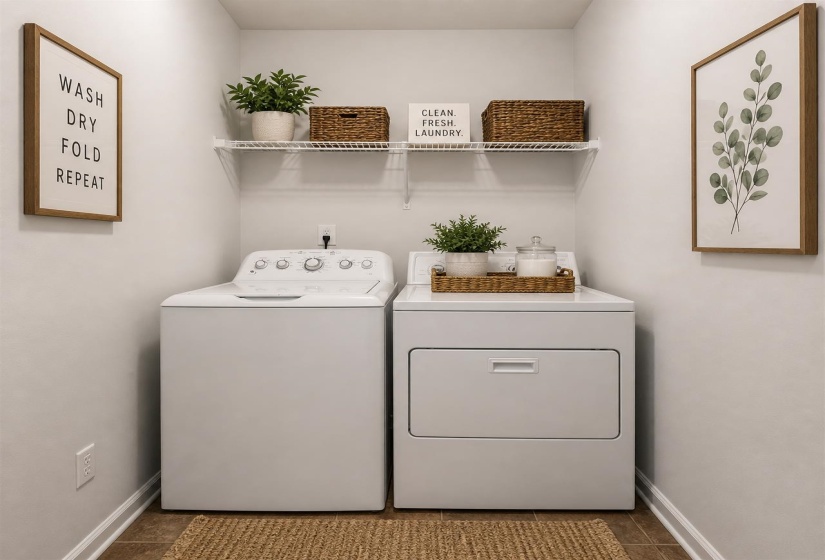 Dedicated laundry area featuring a white top-load washing machine and front-load dryer