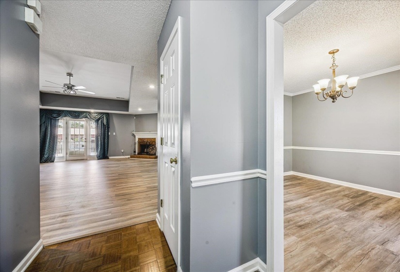 Entryway featuring wood-finish flooring and light gray walls with white trim