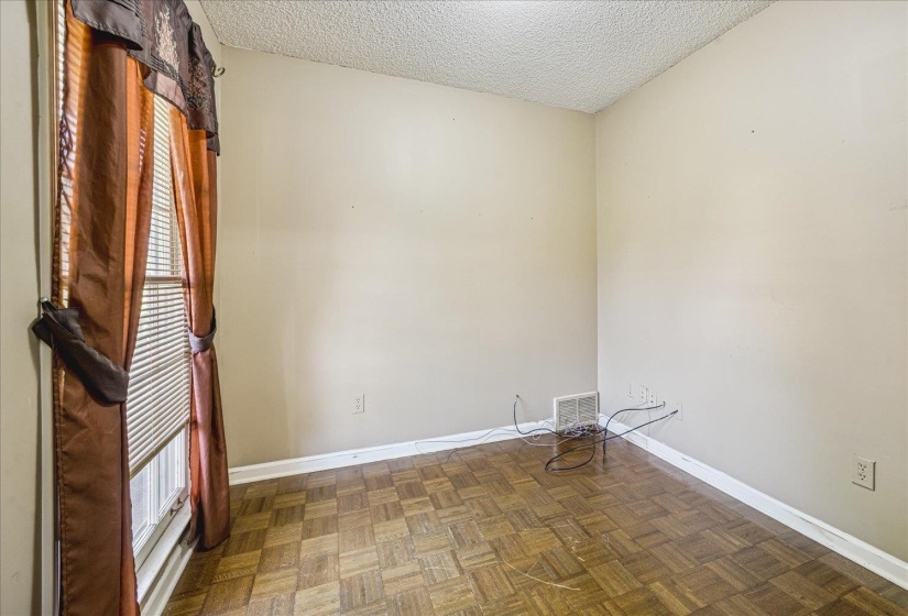 Wood-finish parquet flooring throughout, complemented by neutral wall tones