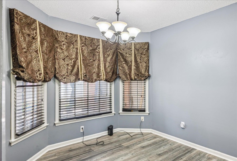 Bay window alcove with wood-finish flooring