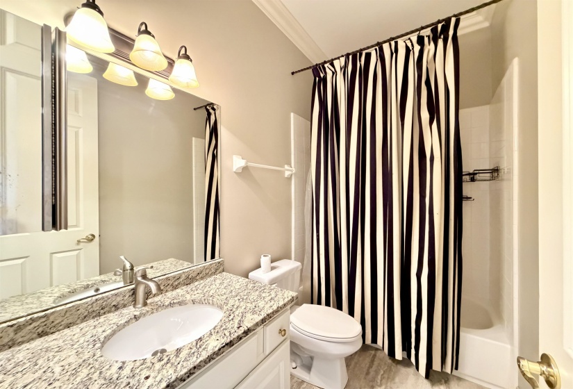 Granite-top vanity with an undermount sink and brushed nickel faucet