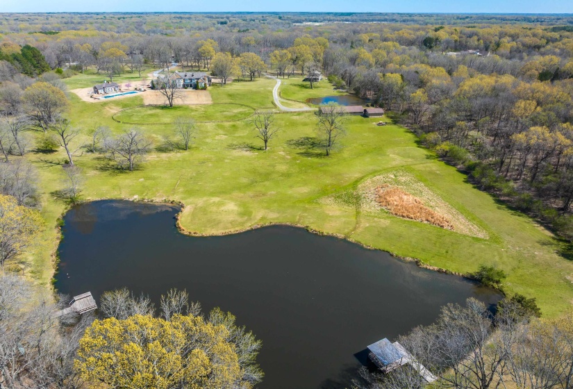 Aerial view featuring a water view and a forest view