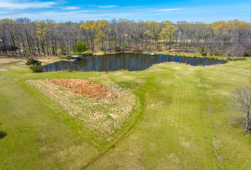 Birds eye view of property featuring a water view and a view of trees