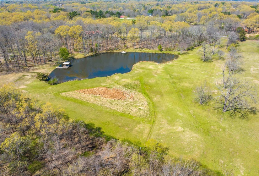 Birds eye view of property with a forest view and a water view