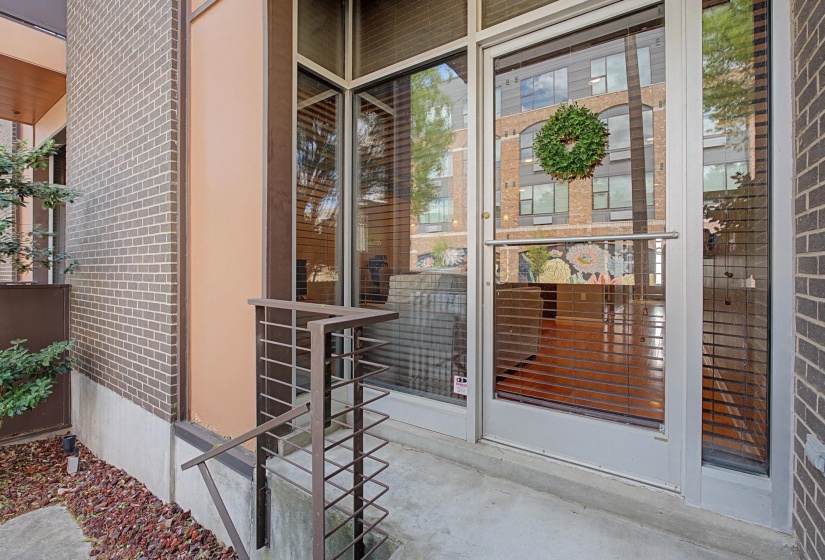 Property entrance featuring brick siding