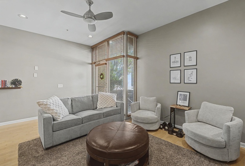 Living room featuring light wood-style floors, ceiling fan, and recessed lighting