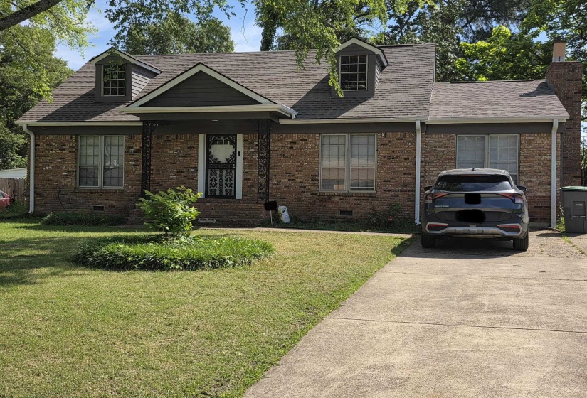 Brick exterior featuring a gabled roofline and two dormer windows
