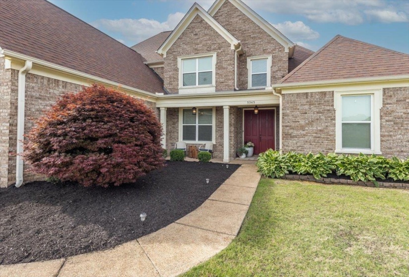 Brick exterior featuring a gabled roofline and an inviting entryway