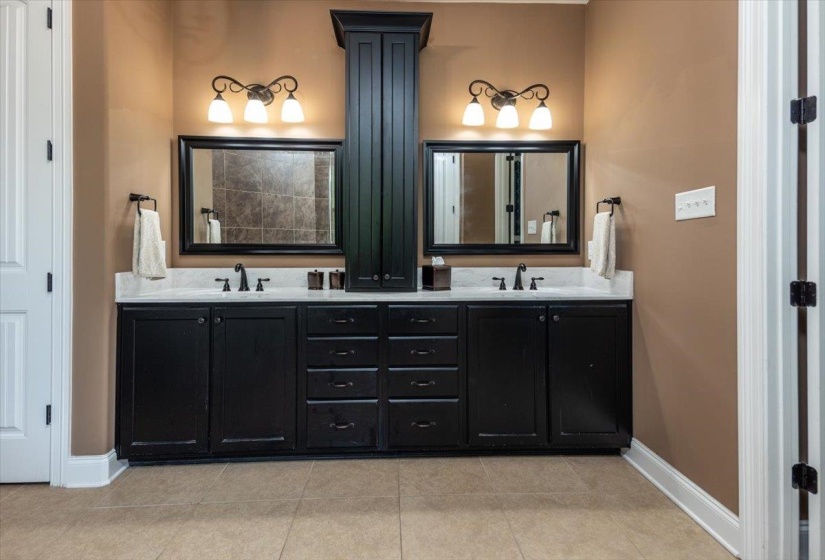 Dual black vanities with white countertops
