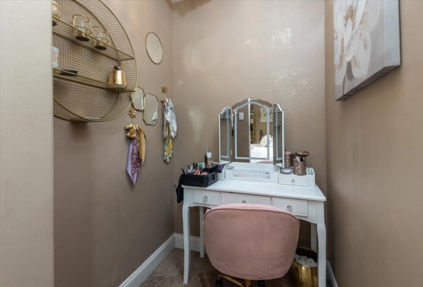 Dedicated alcove featuring an accent wall with a subtle metallic finish